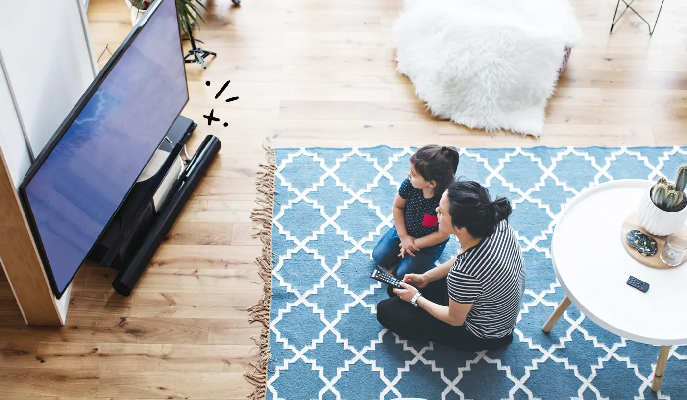 Woman and child watching TV protected by Asurion Home+