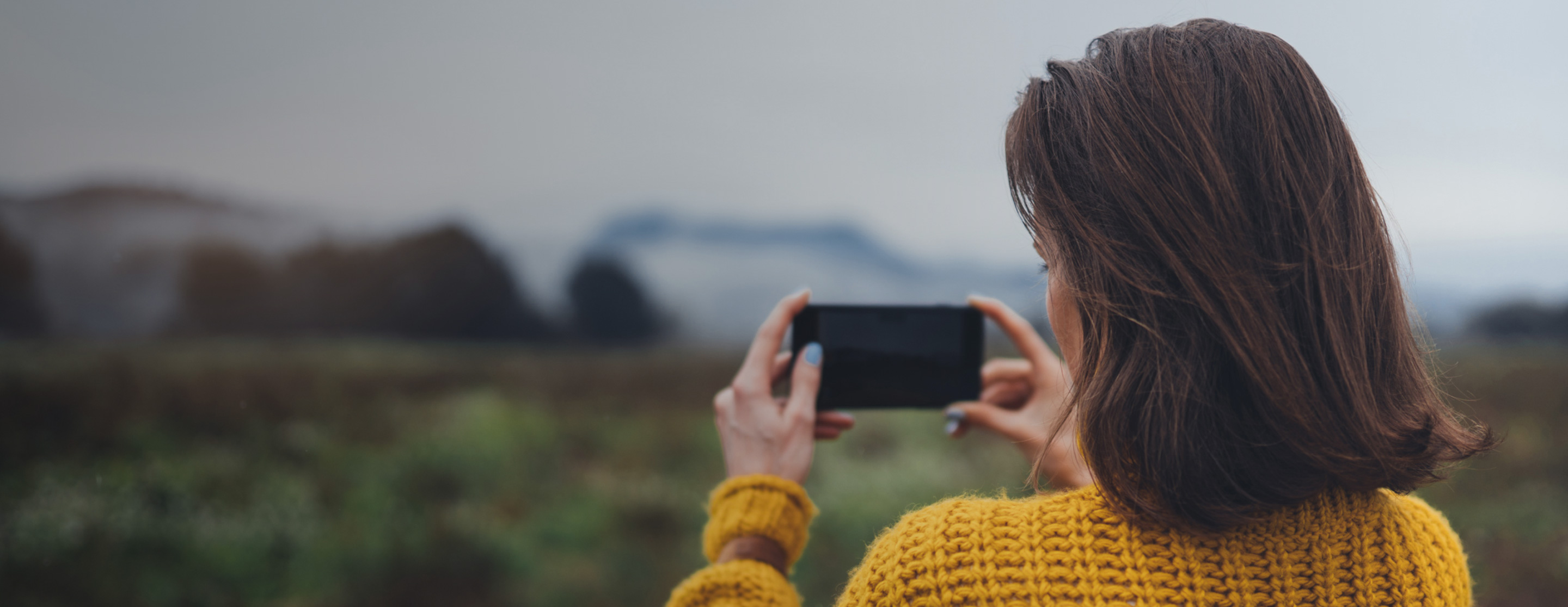 girl taking photo on smartphone