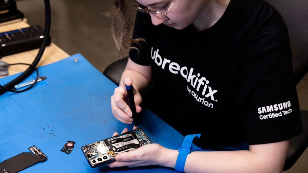 A uBreakiFix by Asurion repair technician works on a Samsung Galaxy smartphone