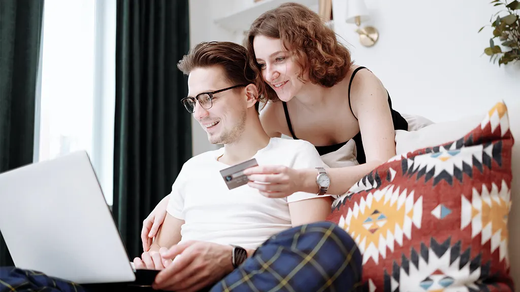 Couple on their laptop online shopping with credit card