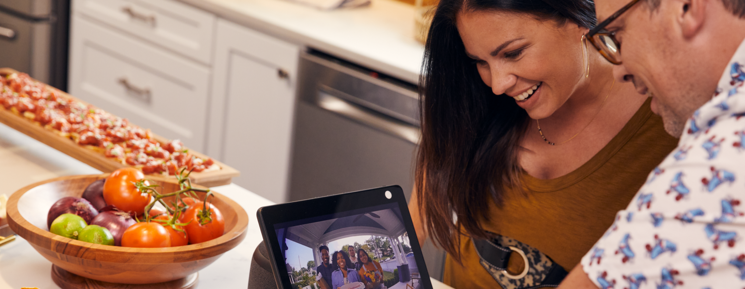 Couple video chatting with friends in kitchen