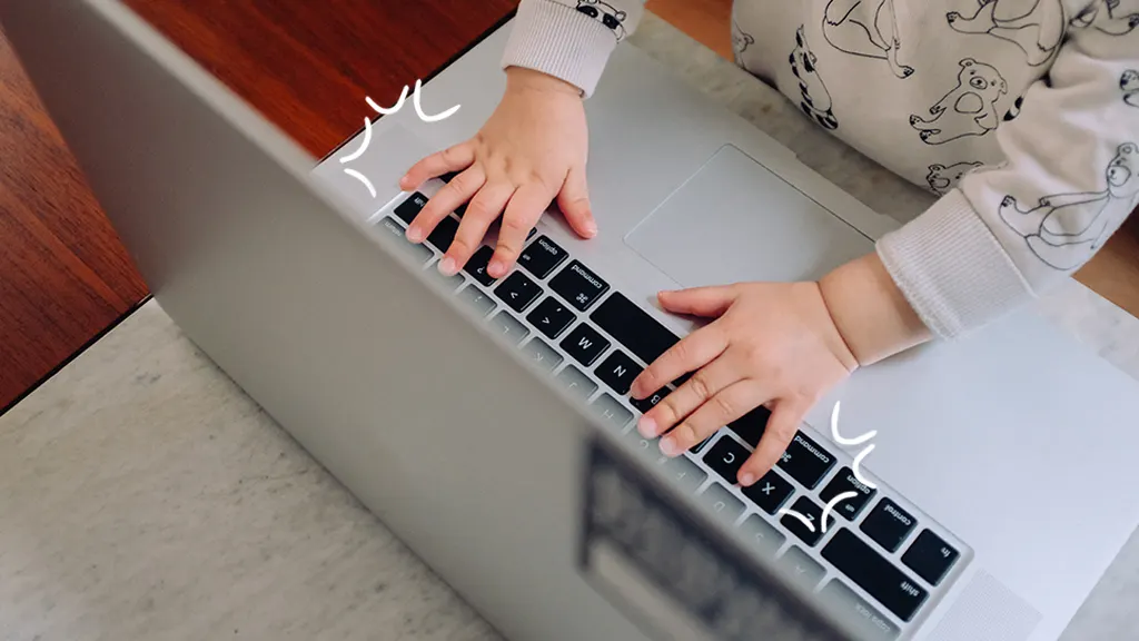 Child's hands on laptop