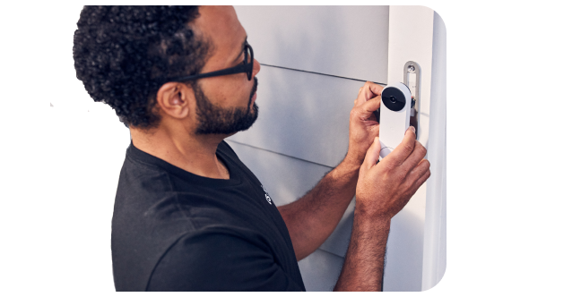 man installing doorbell tech