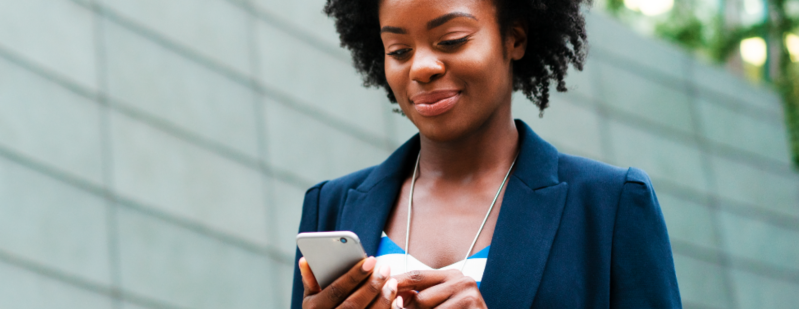 Woman checking phone outdoors